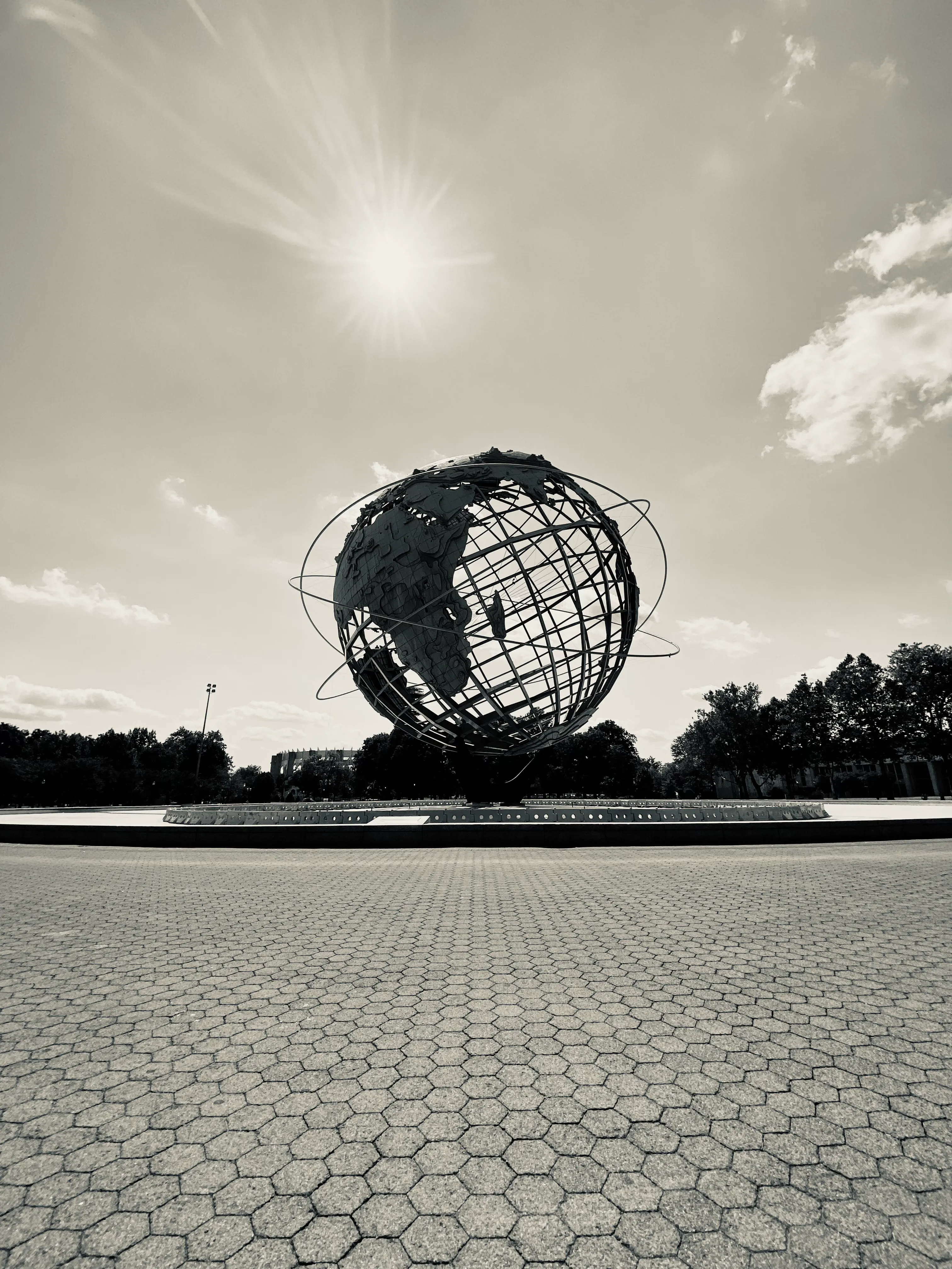The Unisphere is a spherical stainless steel representation of the Earth at Flushing Meadows–Corona Park in Queens, New York City, New York. The globe was designed by Gilmore D. Clarke for the 1964 New York World's Fair. Commissioned to celebrate the beginning of the space age, the Unisphere was conceived and constructed as the theme symbol of the World's Fair.